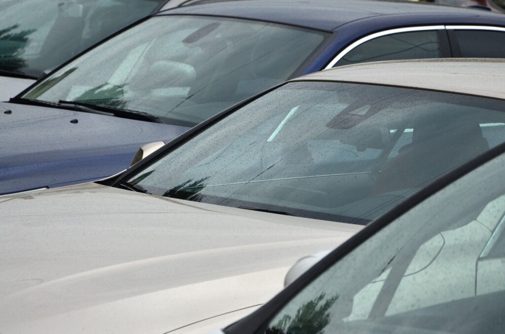 Roofs of several cars. A lot of cars stand close at rush hour